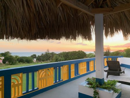 Thatched rooftop palapa at sunset with sea views, Butterfly Hill Villa