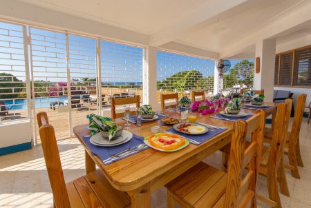 Veranda table set for a meal overlooking the pool, Butterfly Hill Villa